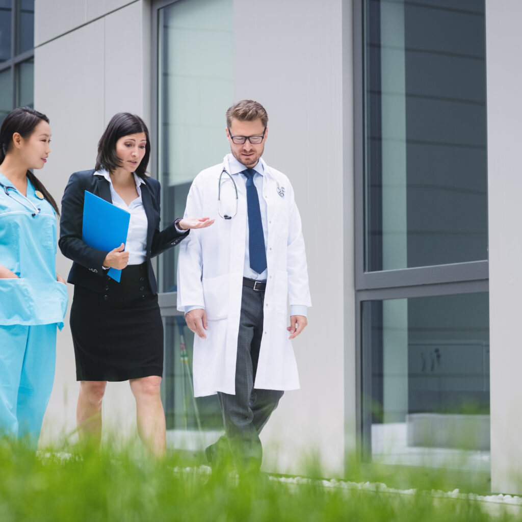 Doctors and nurse interacting while walking in hospital premises